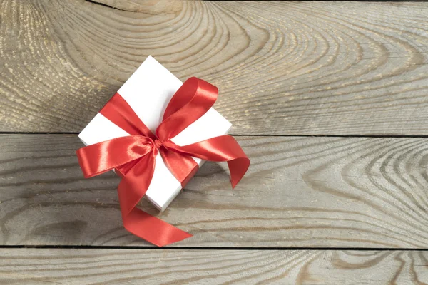 White gift box with red ribbon