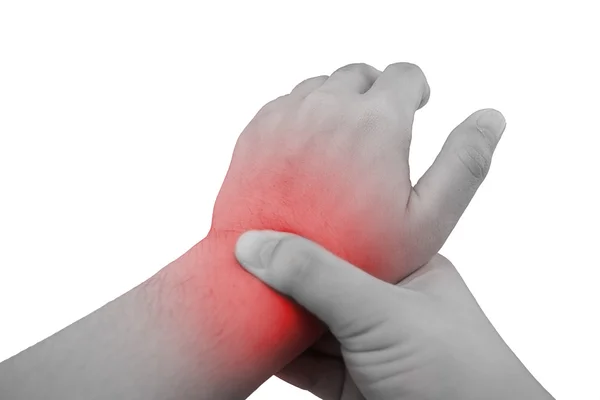 Pain in a wrist. holding hand to spot of wrist pain.