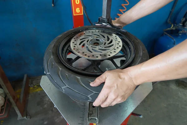 Mechanic removes tire closeup