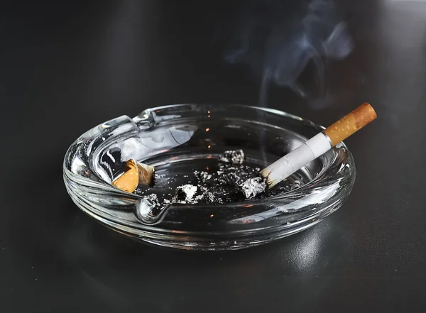 Lit cigarette in the ashtray