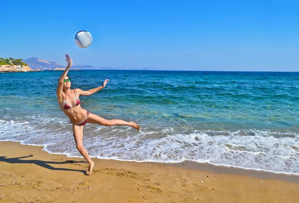 Woman playing volleyball at a greek beach