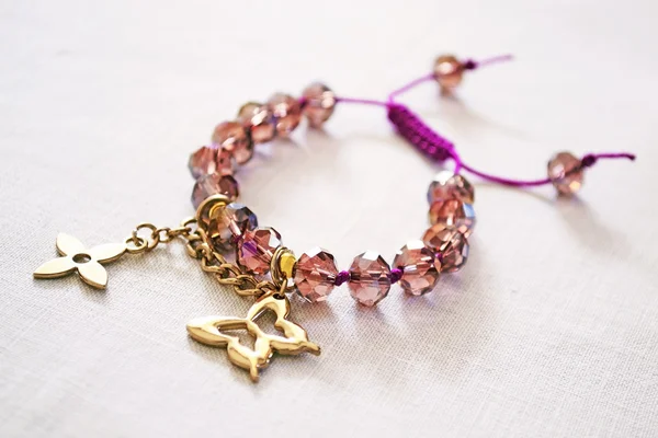 Bracelet with purple beads and gold charms