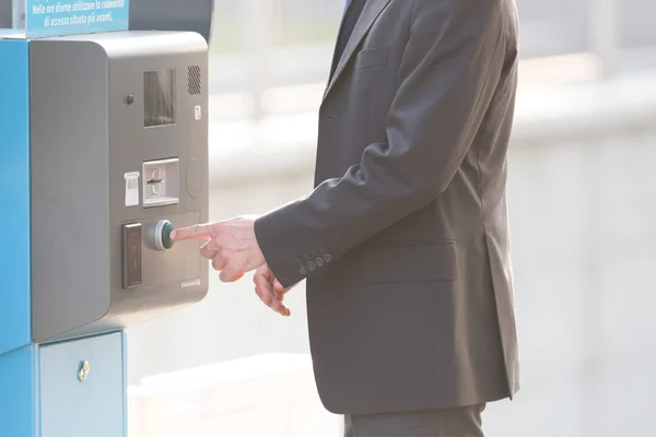 Businessman and a parking ticket pay machine