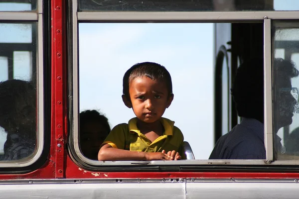 Tamil boy sitting in the bus and looking outside