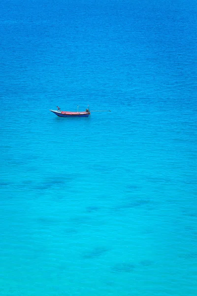 The boat in the azure ocean