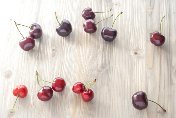 Scattered cherries on aged wood