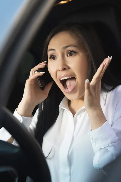 Young pretty scared woman in the car