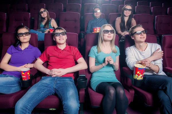 People in the cinema wearing 3d glasses