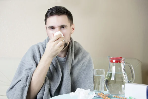 Man cold flu illness tissue blowing runny nose. Man blowing his nose