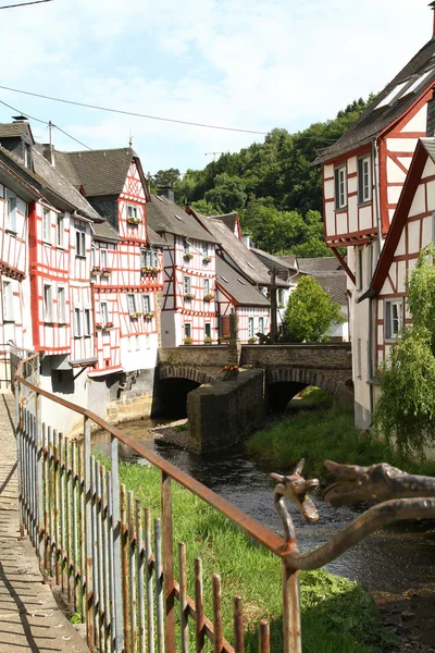 Creek lined with historic houses and wrought iron railing in the medieval village Monreal
