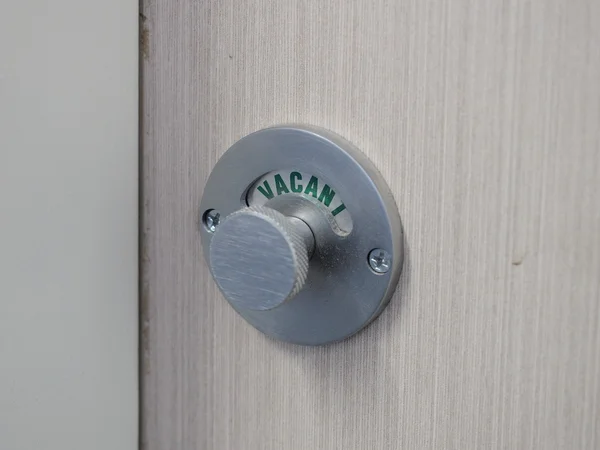 Lock of a shower cubicle indicating green Vacant position