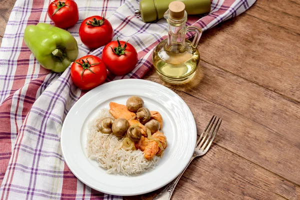 Rice with meat and mushrooms in round plate