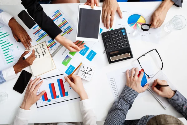 Picture of businessmens hands on white table with documents and drafts