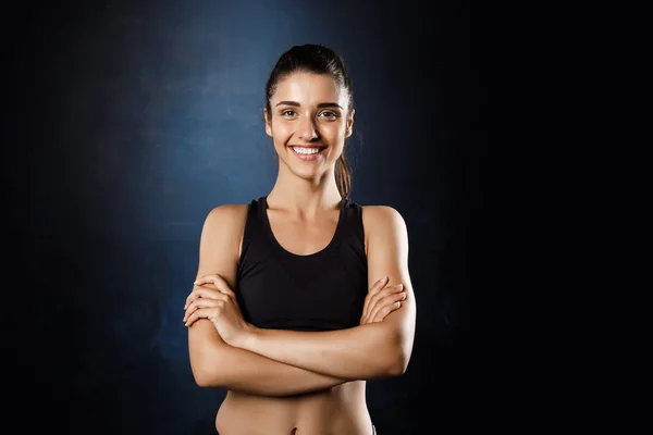 Sportive girl with crossed arms