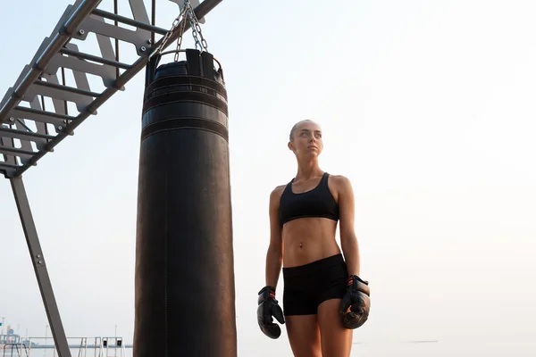 Sportive woman training boxing