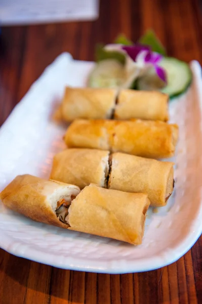 Selection of pancake rolls on a plate in a restaurant cut in half