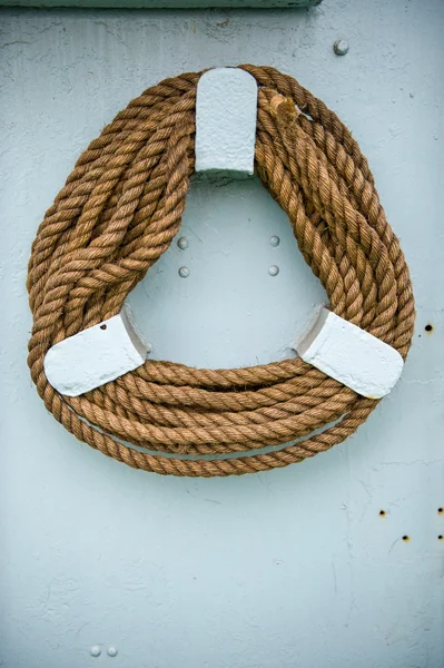 Close up of ships rope on holder on wall of ship