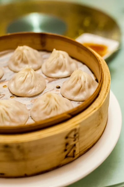 Soup dumplings served in bamboo steamer