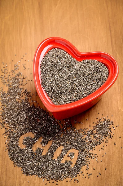 Chia seeds on the wooden background.