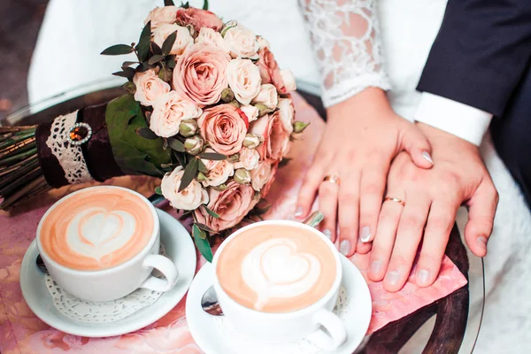 Man and woman's, coffee, bridal bouquet of flowers.