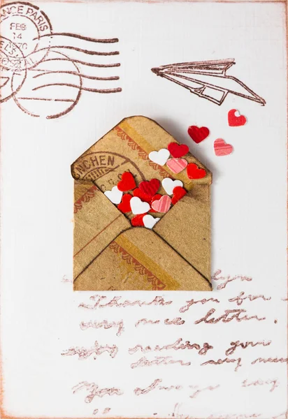Decorative hearts are in a old postal envelope