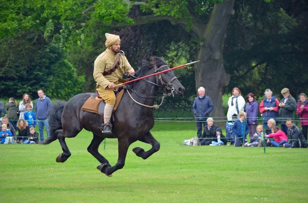 Demonstration of the sport of Tent Pegging at full gallop  by a member of the Punjab Lancers in World War One uniform