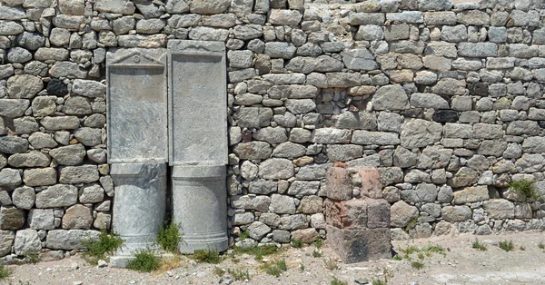 Stone wall and pillars Ancient Thira Santorini Greece.