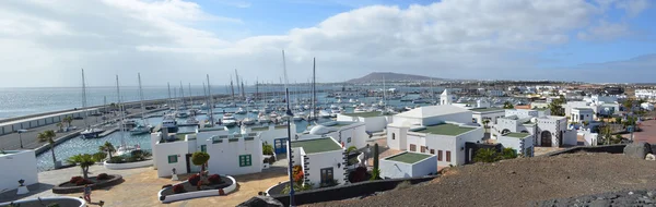 The  marina area of  Playa Blanca Lanzarote Spain with yachts and shops.