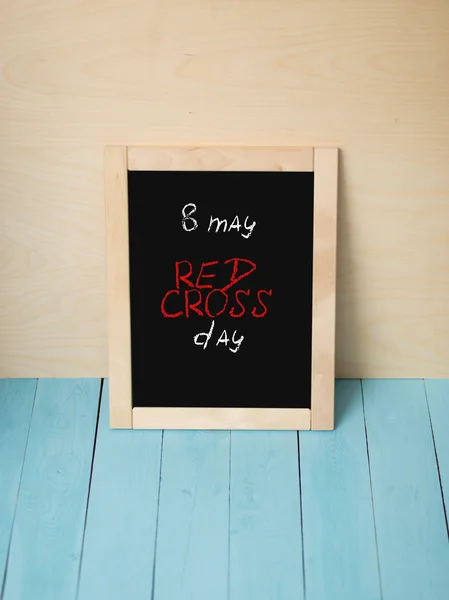 Eight of may, Red Cross Day , lettering on black desk