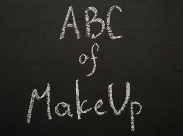 ABC of make up chulk title on black desk.