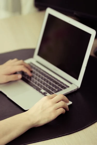 Black screen on laptop, men's hands typing, vintage colors