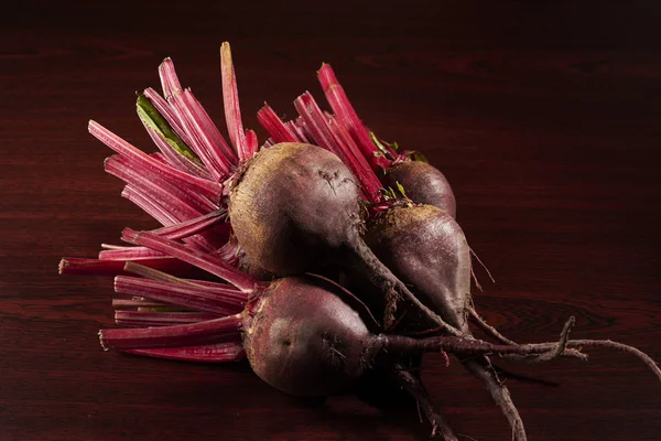 Three red beets on the table