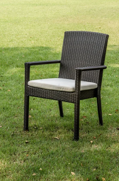 Rattan chair with cushion in the garden