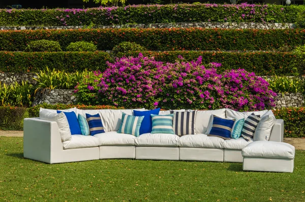 Water resistant outdoor sofa with cushions, pillows in the garden