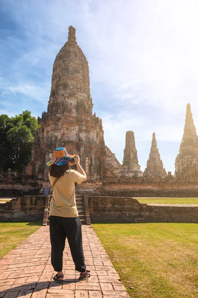 Rear view of tourism taking photo at Wat Chaiwatthanaram Buddhist temple in the city of Ayutthaya Historical Park at Ayutthaya,Thailand.