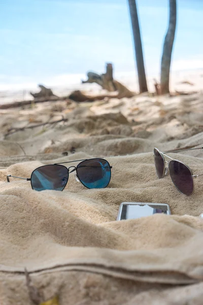 Flip flops, sunglasses, towel on the beach
