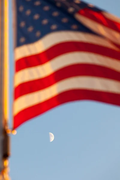American flag flying and a Moon