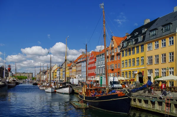 Scenic summer view of Nyhavn pier with old buildings, ships, yac