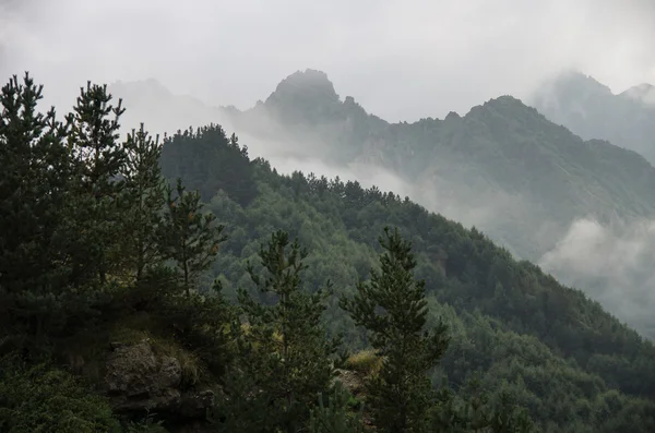View of mountains in the clouds after storm in valley near Georg