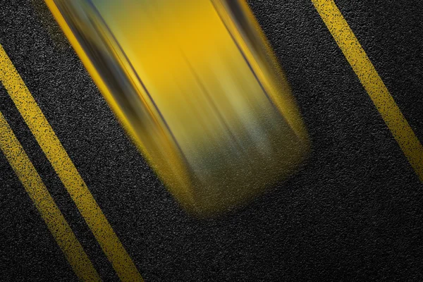 Level asphalted road with a dividing yellow stripes and moving with at high speed the vehicle cab. The texture of the tarmac, top view.