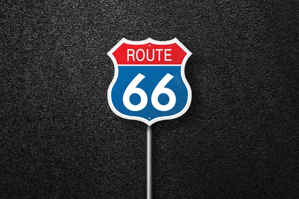 Road sign with the words 66 on a background of asphalt. Route 66. Will Rogers highway. The texture of the tarmac, top view.