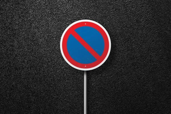 Road sign circular shape on a background of asphalt. The texture of the tarmac, top view.