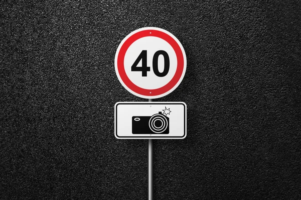 Road signs of the circular shape on a background of asphalt. Speed-limit cameras. The texture of the tarmac, top view.