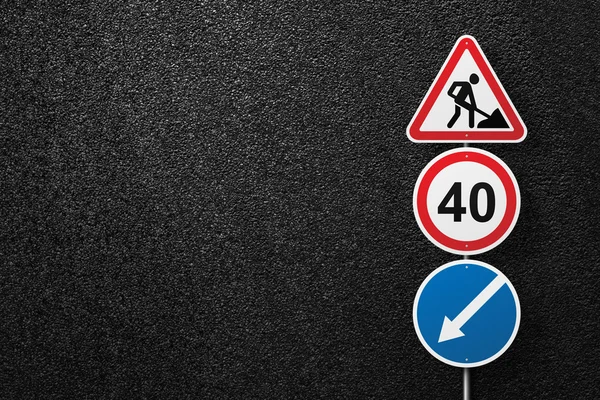 Road signs of the circular and triangular shape with a picture of a worker on a background of asphalt. Speed limit. The texture of the tarmac, top view.