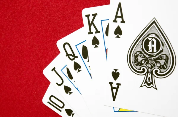 Biggest hand in Poker game on red background