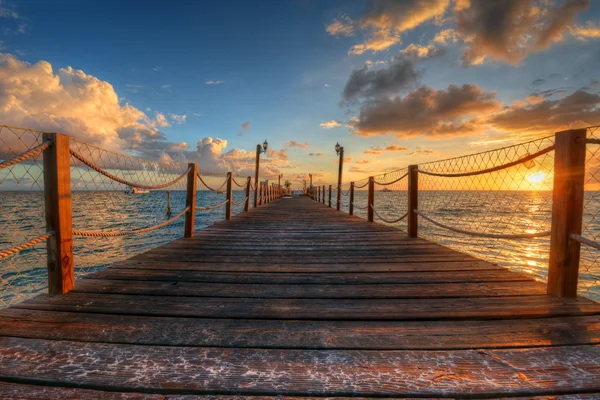 Brilliant sunrise on a sea pier