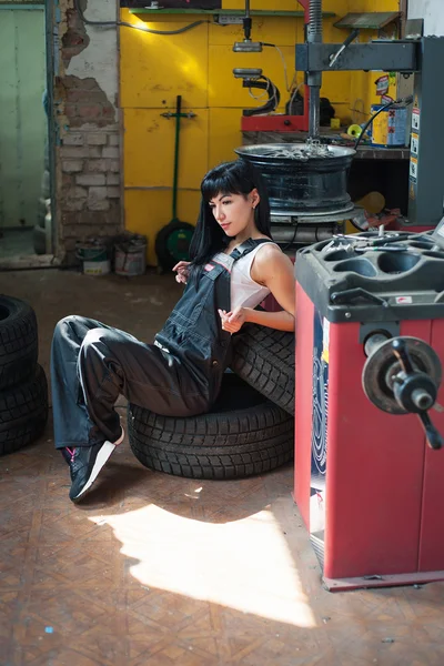 woman auto mechanic in tire