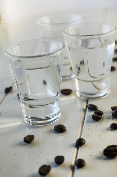 Sambuca in shot glasses and coffee beans