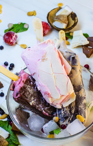 Varied ice cream with fruits and berries in chocolate