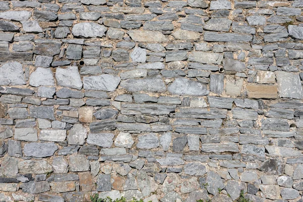 Stone wall from weathered variety gray stones